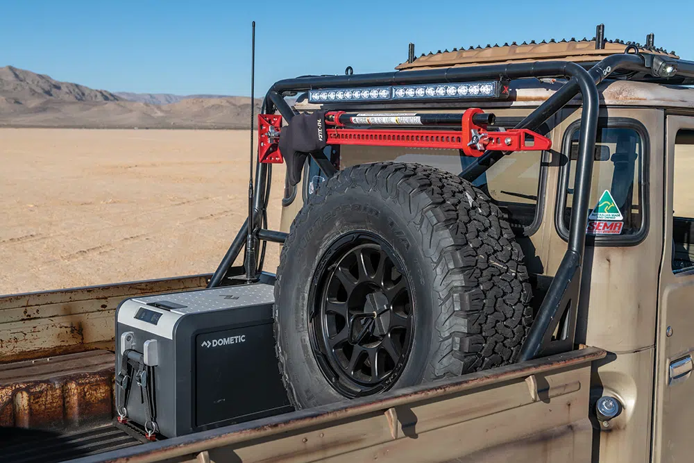The bed houses a spare tire, Dometic fridge, and Hi-Lift jack