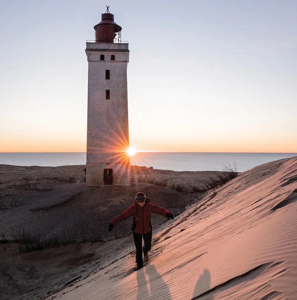 Lisa dimples the sand at the remarkably relocated lighthouse near Hirtshals