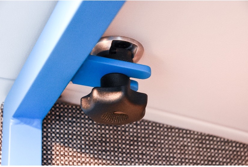 Mac's Tie Down threaded knob attached to roof of fan secures blue brace.