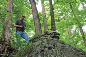 Alex Mace uses his remote control to stand safely back as he senads his RC off a rock face