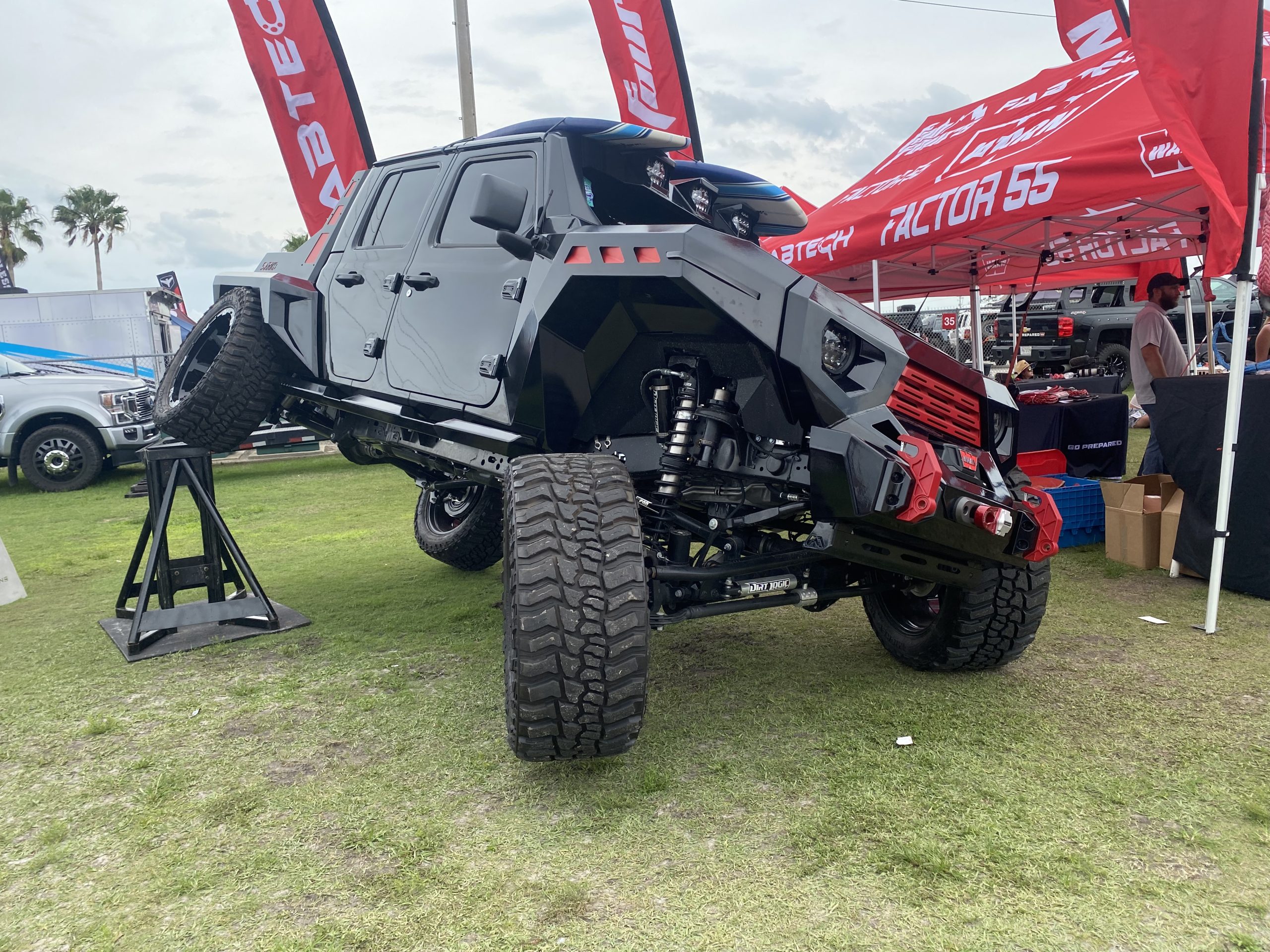 Black Jeep Gladiator flexing on grass.