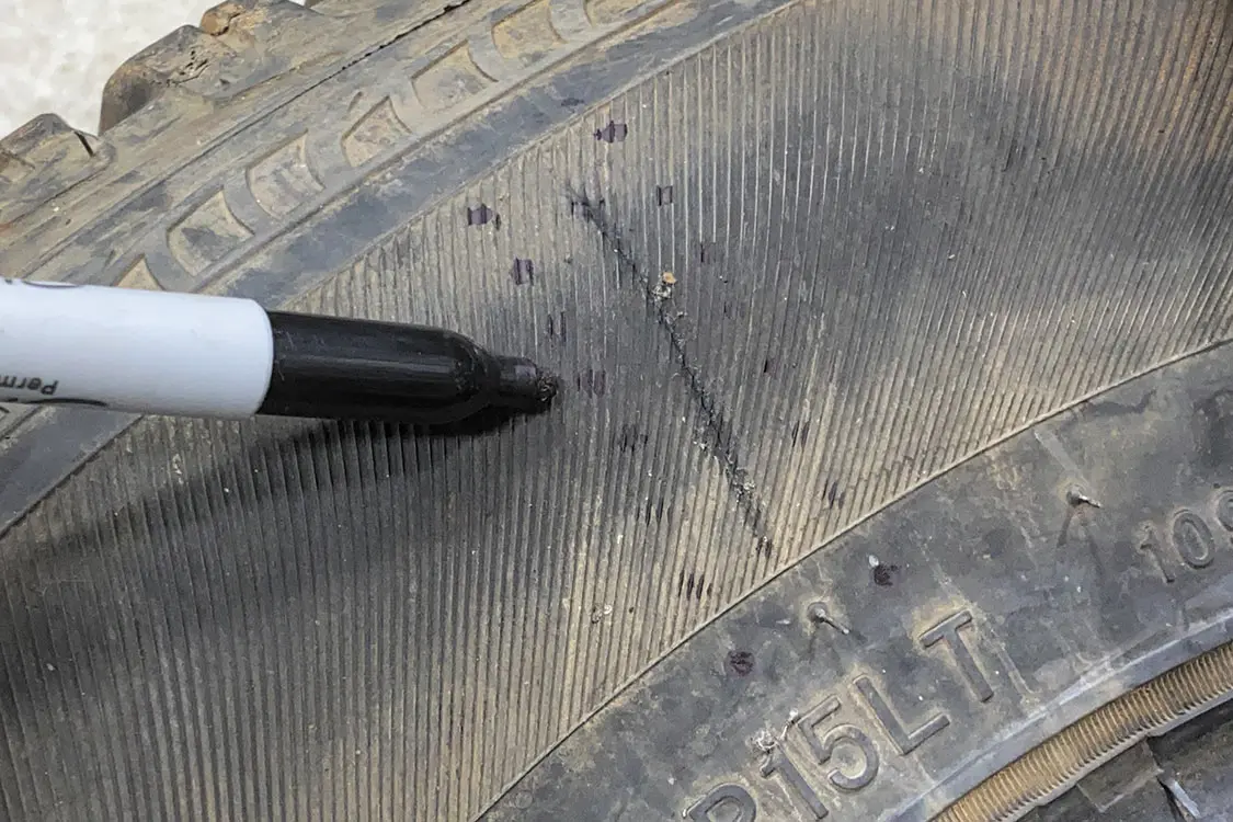 Create a line of evenly spaced holes on other side of tire