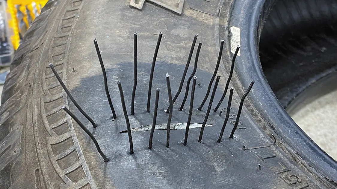 Starting nearest to the tread block, push each suture through from the inside, making sure not to skip a hole.