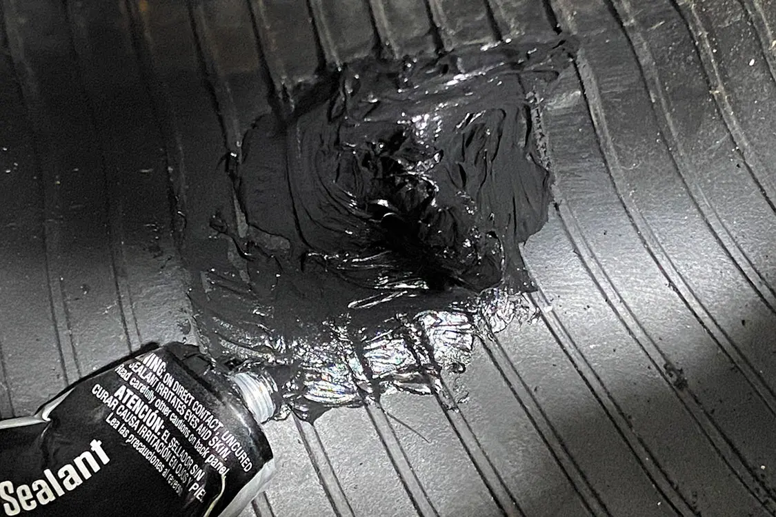 Working on the inside of the tire, apply a heavy layer of RTV silicon along the inserted plugs and over suture holes
