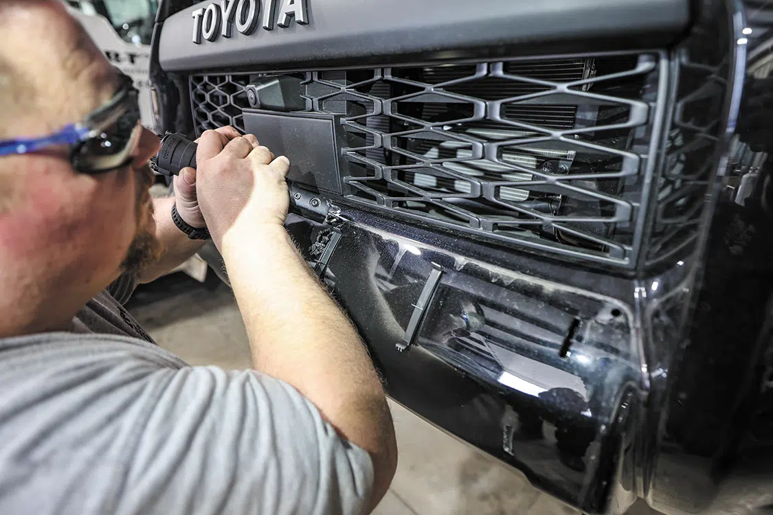 An air saw makes quick work of cutting along the Sharpie mark to remove the inner section of the lower bumper