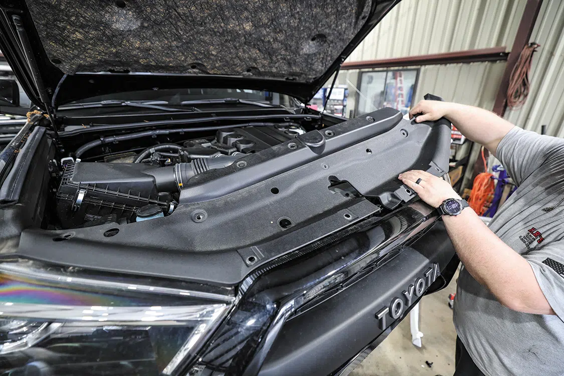 The upper front cover panel was then removed to access behind the grille