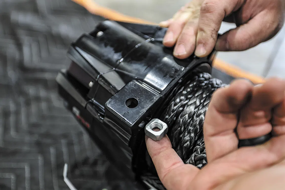 Slide the nuts into the mounting feet of the winch