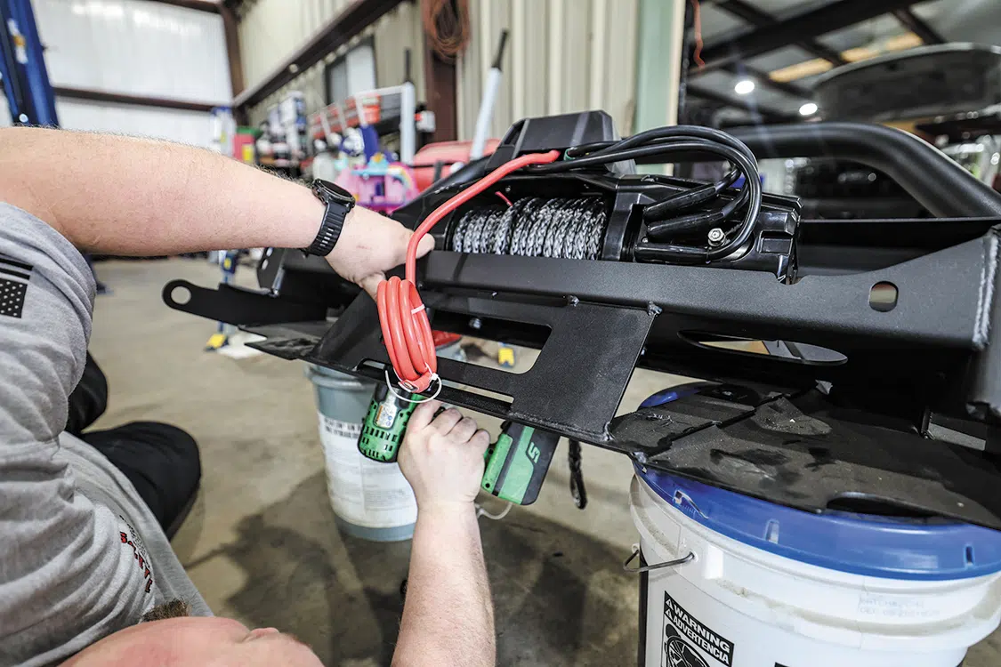 With the winch set in place, we used the supplied bolts to secure it and then removed the tape